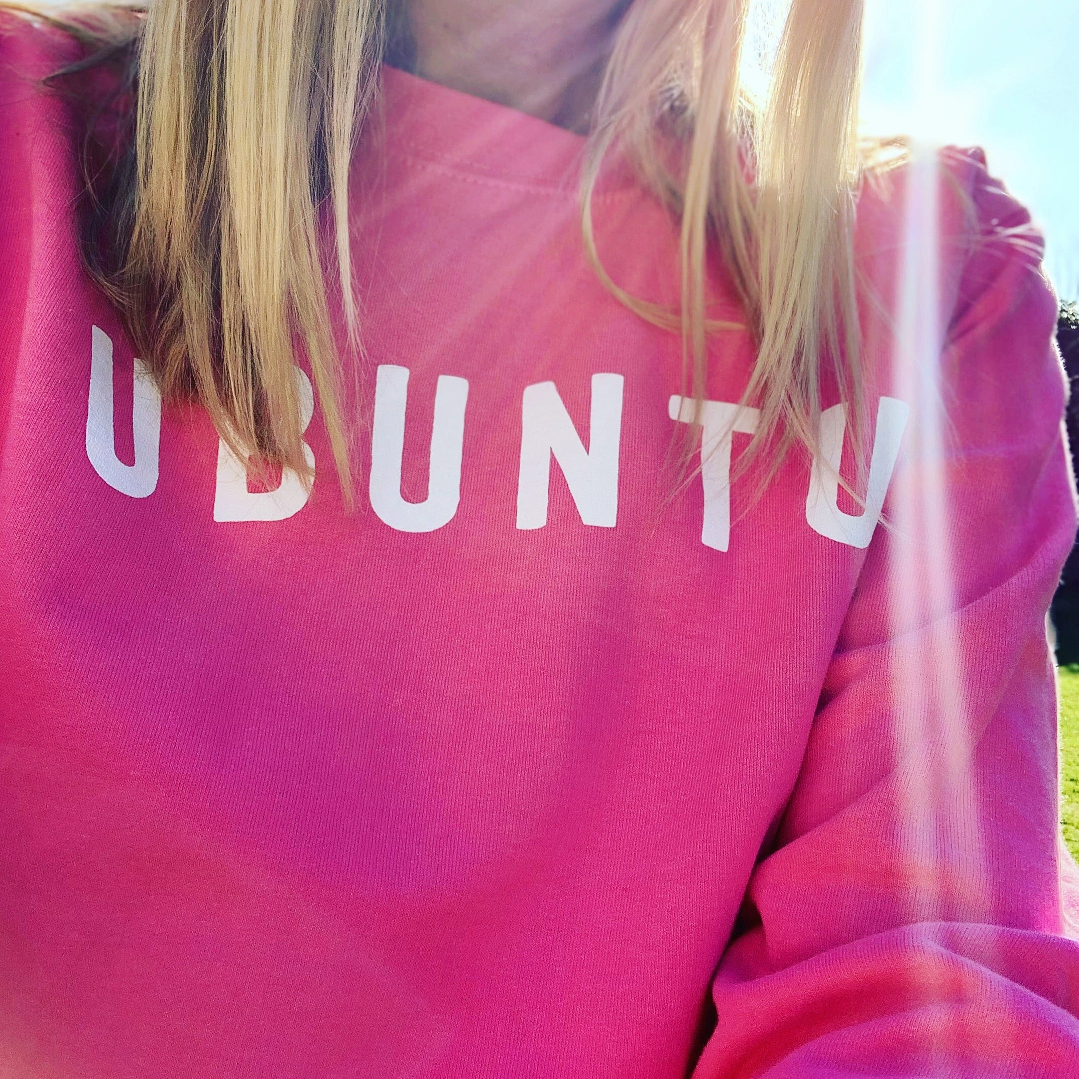 White UBUNTU on bright pink sweatshirt